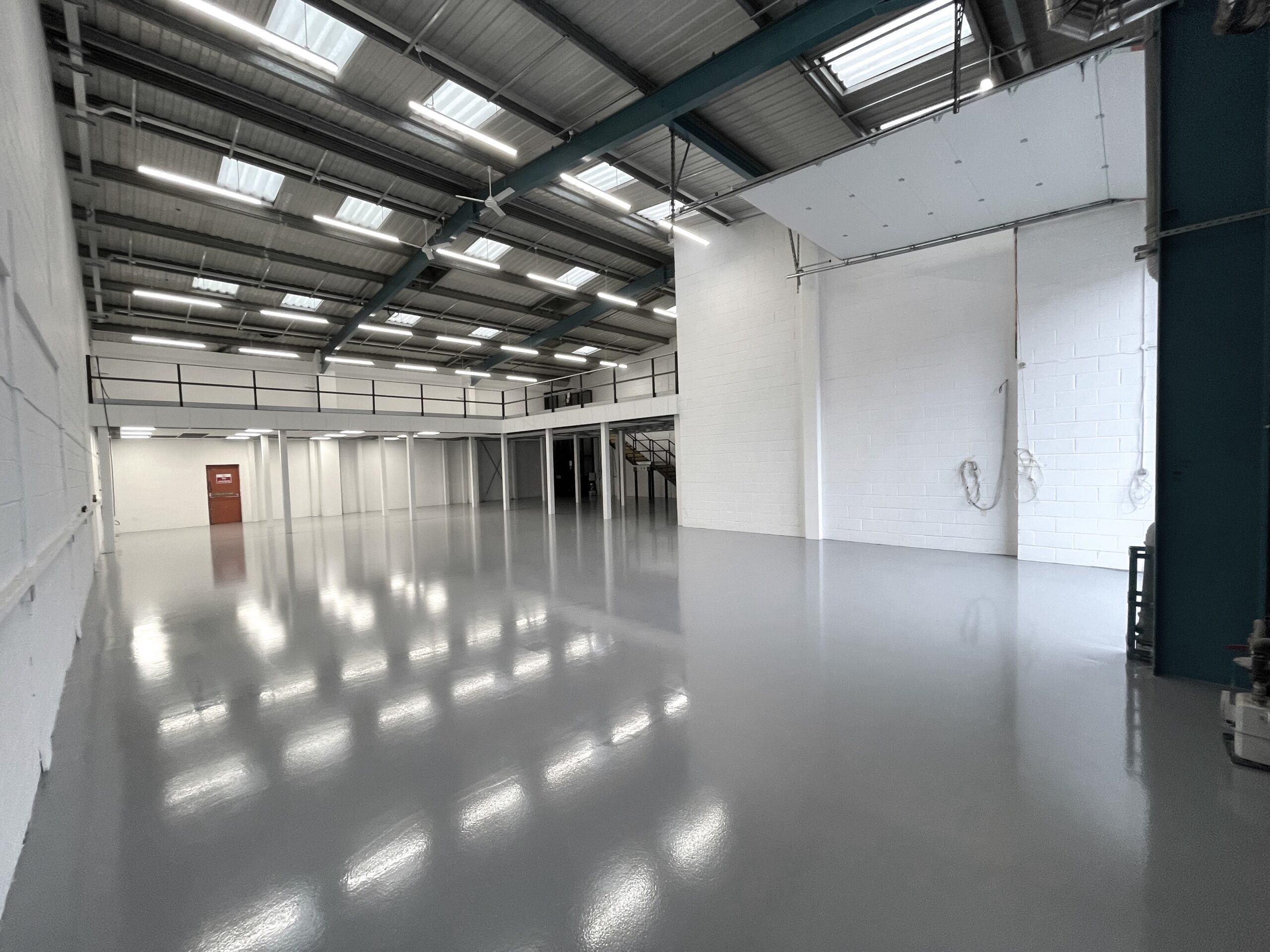 Grey epoxy flooring in empty warehouse