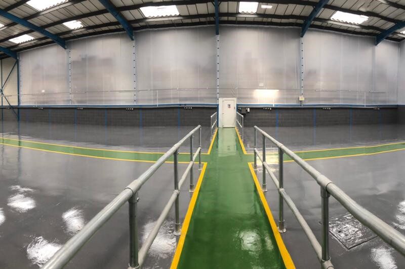 Grey epoxy flooring with green and yellow lines