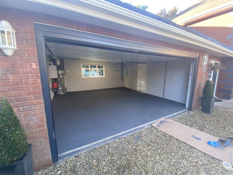 Open double garage with flake floor