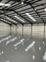 Large warehouse with shiny grey epoxy flooring