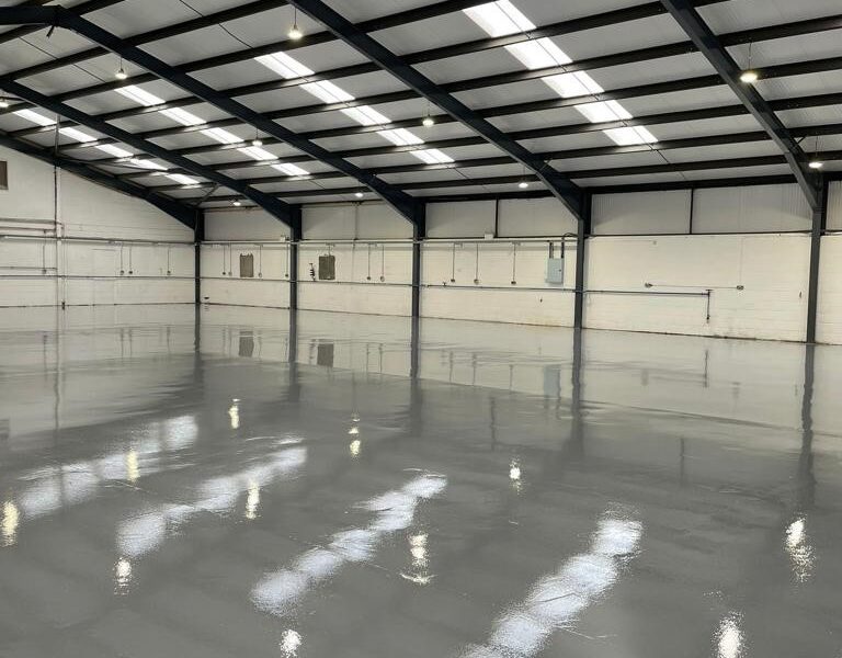 Large warehouse with shiny grey epoxy flooring