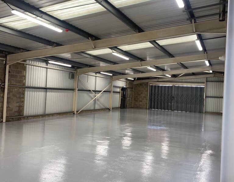 Grey epoxy flooring in empty warehouse